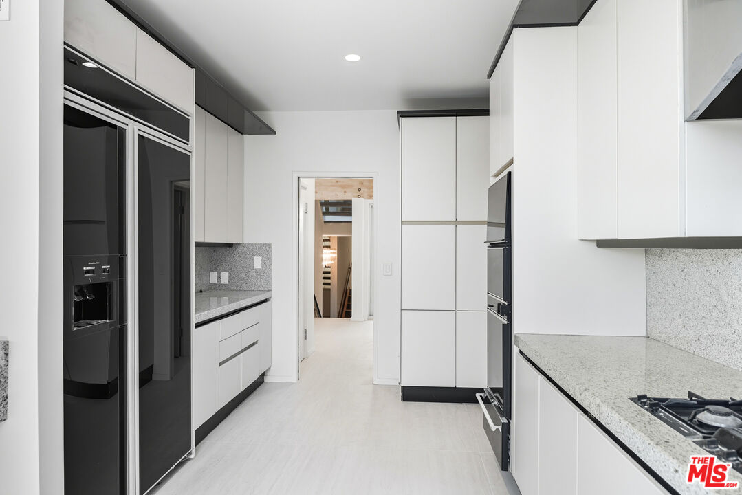 1591 Lindacrest Drive Beverly Hills, CA 90210 - Photo 7 of 17 a kitchen with stainless steel appliances a refrigerator and a sink