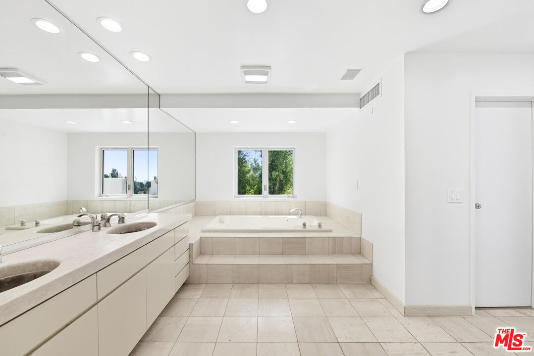 1591 Lindacrest Drive Beverly Hills, CA 90210 - Photo 9 of 17 a bathroom with a tub a sink and a window