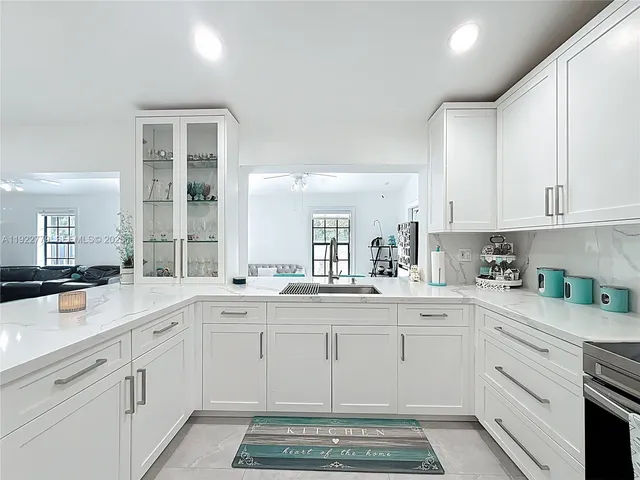 a kitchen with a sink stove and cabinets