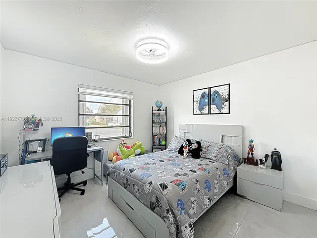 a bedroom with a bed a couch and a window