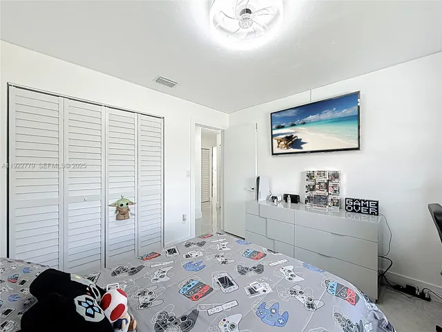 a bedroom with a bed and a dresser