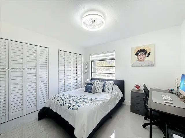 a bedroom with a bed and a table in it