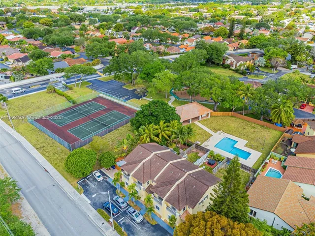 an aerial view of a houses with a yard