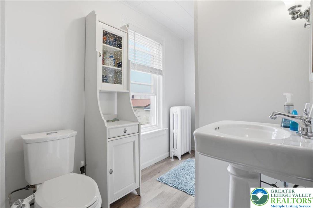 525 Ridge Street Emmaus, PA 18049 - Photo 40 of 68 This bright bathroom features a pedestal sink and toilet, complete with a window for natural light.