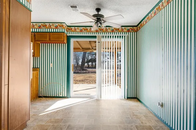 a view of a room with wooden floor