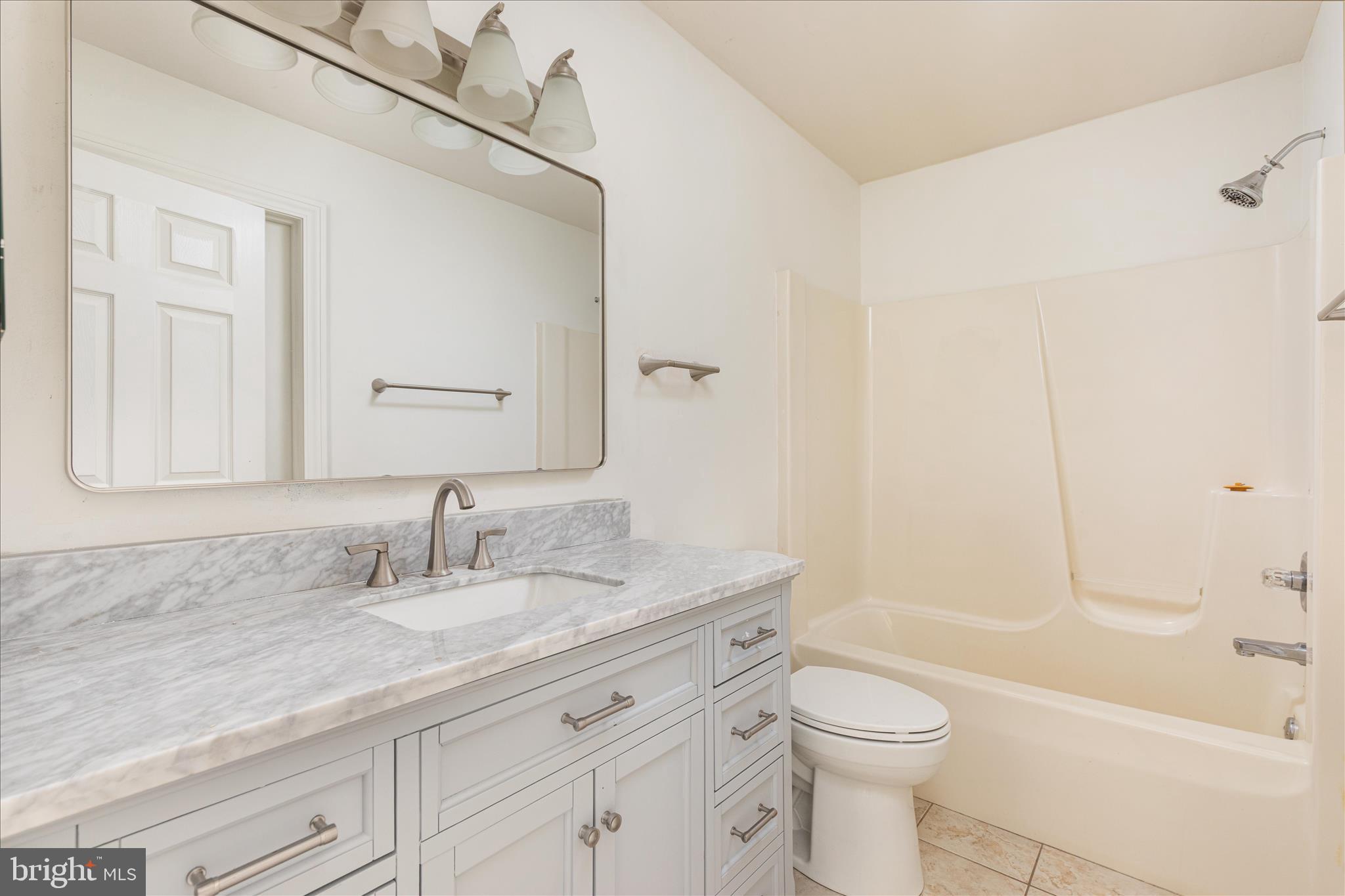 1200 Salem Church Road Stephens City, VA 22655 - Photo 18 of 69 a bathroom with a granite countertop sink a toilet and a bathtub