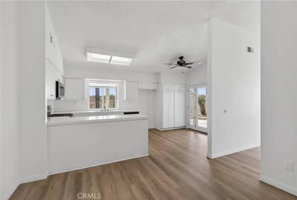 a kitchen with a sink and steel appliances