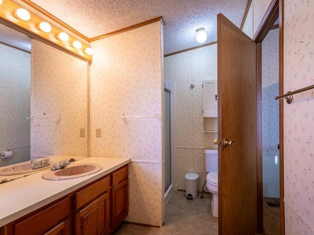 4713 Fox Hollow Road Graham, TX 76450 - Photo 18 of 39 a bathroom with a granite countertop sink toilet and shower