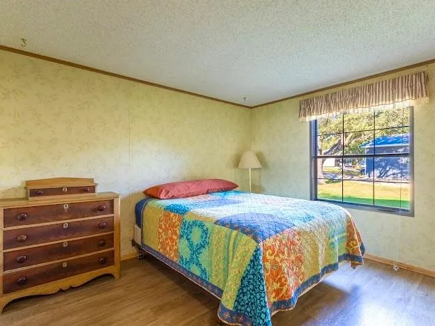 a bedroom with a bed and large window