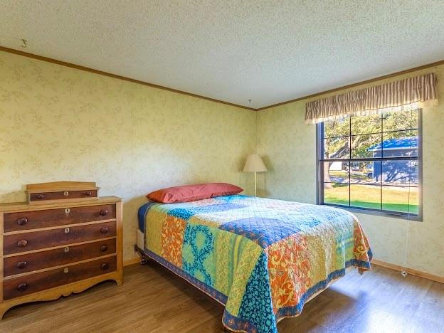 4713 Fox Hollow Road Graham, TX 76450 - Photo 21 of 39 a bedroom with a bed and large window