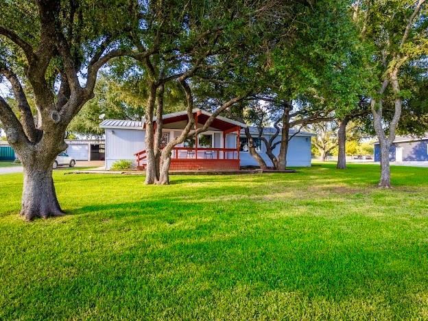 4713 Fox Hollow Road Graham, TX 76450 - Photo 4 of 39 a view of a house with a big yard and large trees