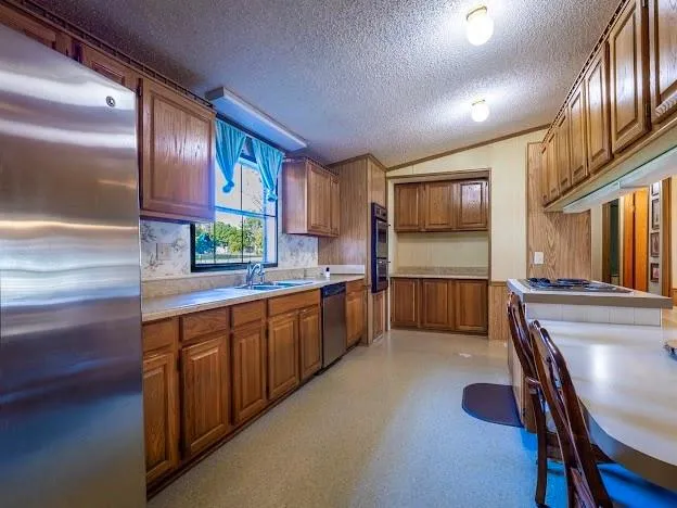a kitchen with stainless steel appliances sink microwave and cabinets
