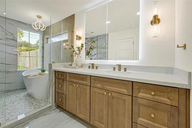 a bathroom with a double vanity sink a mirror and a bathtub