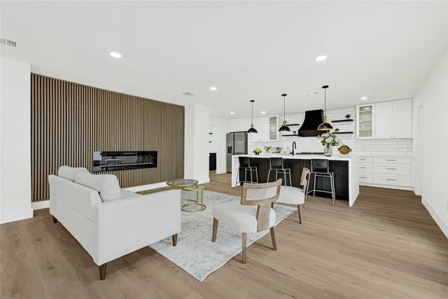 a living room with kitchen island furniture and a wooden floor