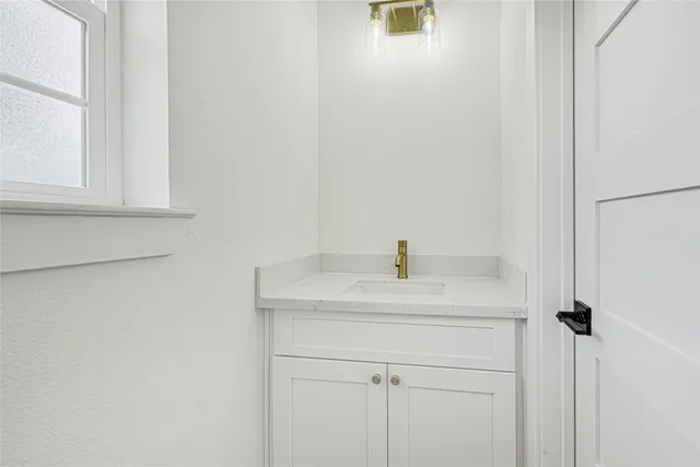 a bathroom with a sink and vanity