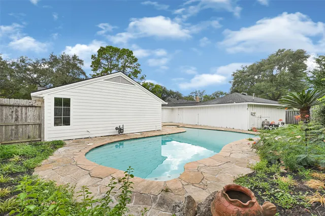 a view of a house with a yard and a garden