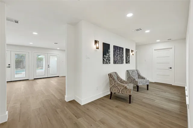 a living room with furniture and a wooden floor