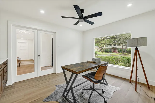 a view of a workspace with furniture and a window