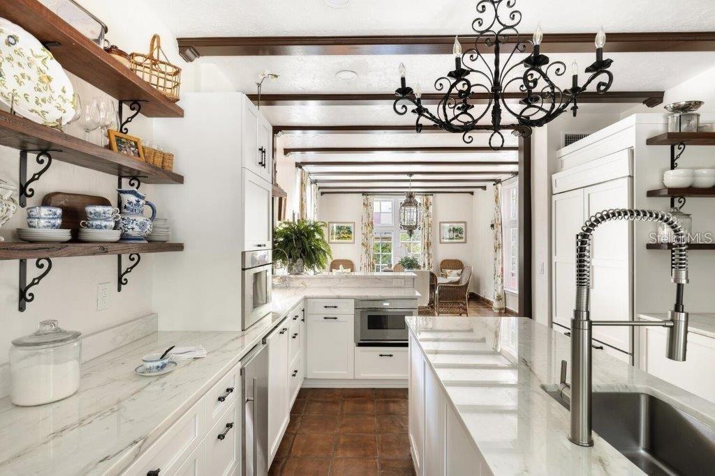 4511 Bay Shore Road Sarasota, FL 34234 - Photo 17 of 69 a kitchen with stainless steel appliances a white stove top oven and cabinets