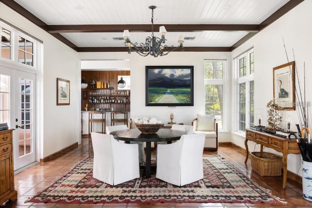 4511 Bay Shore Road Sarasota, FL 34234 - Photo 20 of 69 a dining room with wooden floor and chandelier