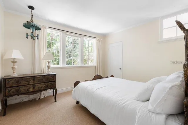 an aerial view of a house with a yard and lake view