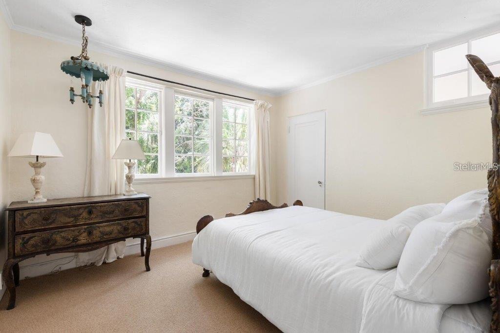 4511 Bay Shore Road Sarasota, FL 34234 - Photo 37 of 69 a bedroom with a bed and a dresser next to a window