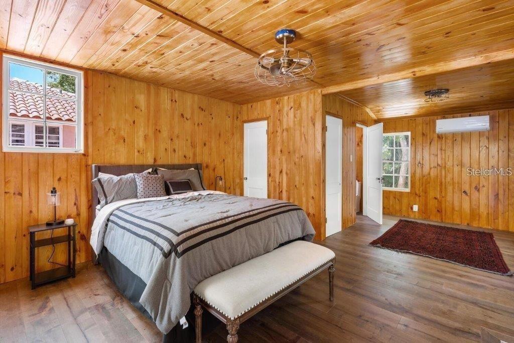 4511 Bay Shore Road Sarasota, FL 34234 - Photo 44 of 69 a spacious bedroom with a bed and wooden floor