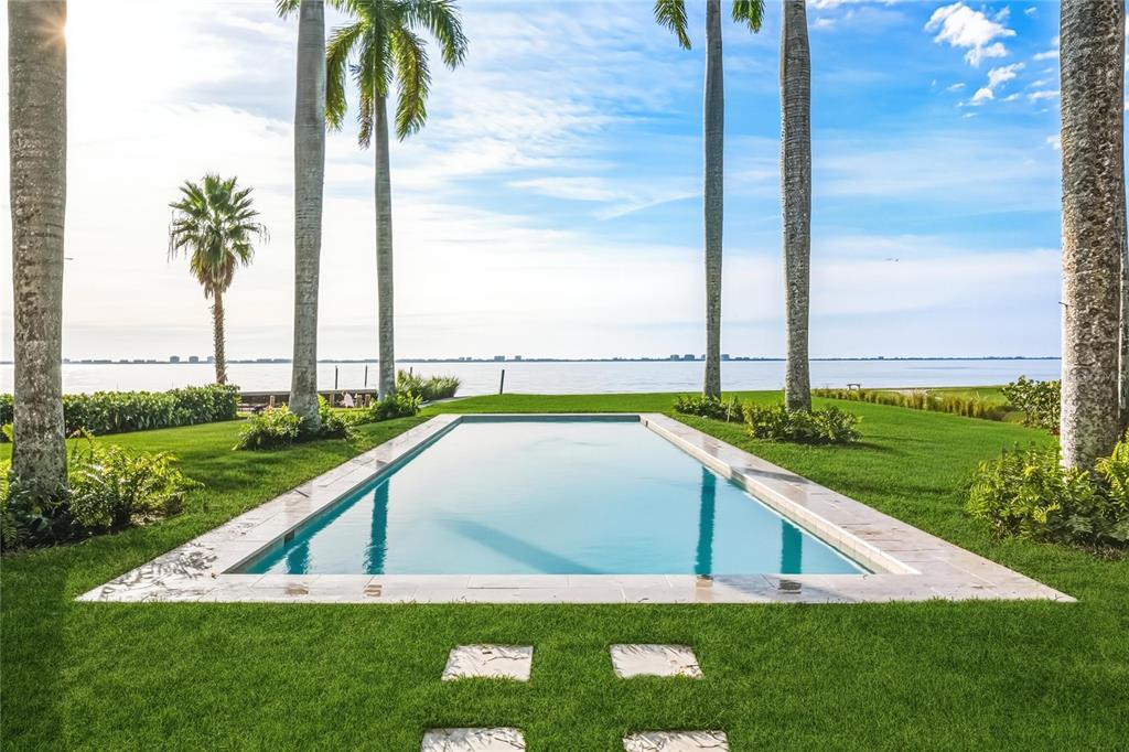 4511 Bay Shore Road Sarasota, FL 34234 - Photo 55 of 69 a view of swimming pool with a yard and palm trees