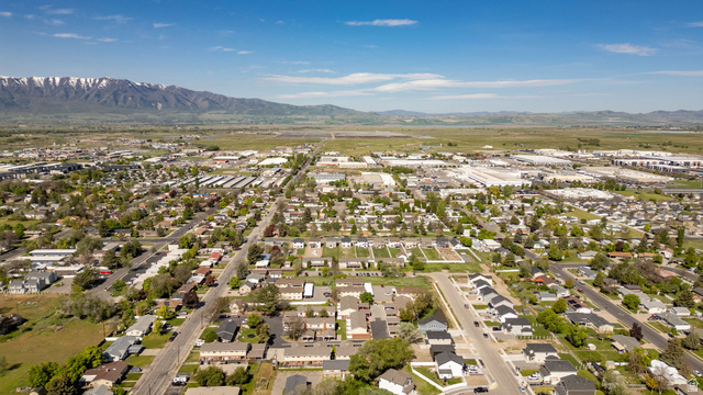 283 West 600 North, Unit 2 Logan, UT 84321 - Photo 25 of 36 Expansive aerial perspective showcasing a residential district with a backdrop of snow-capped mountains