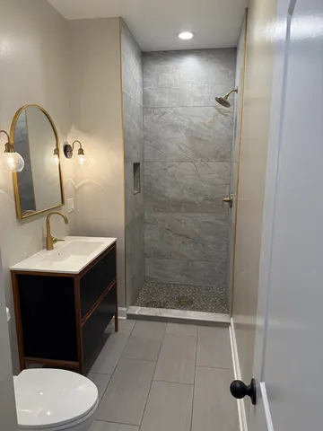 a bathroom with a sink toilet and shower