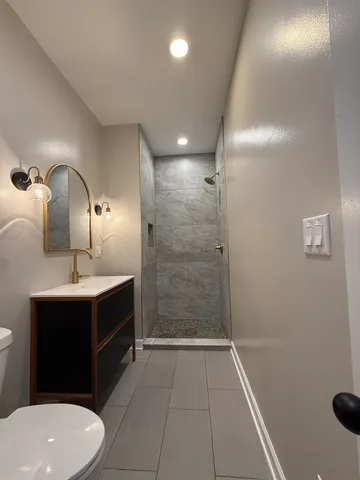 a bathroom with a sink toilet and shower