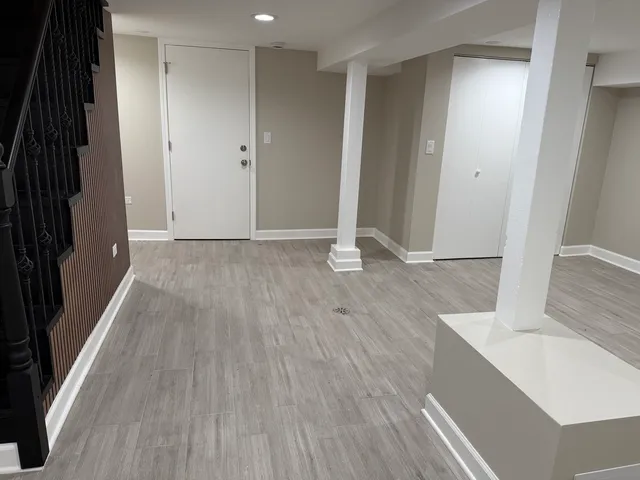 a view of wooden floor and cabinets in a room