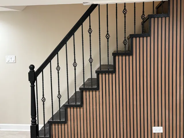 a view of staircase with wooden floor and white walls