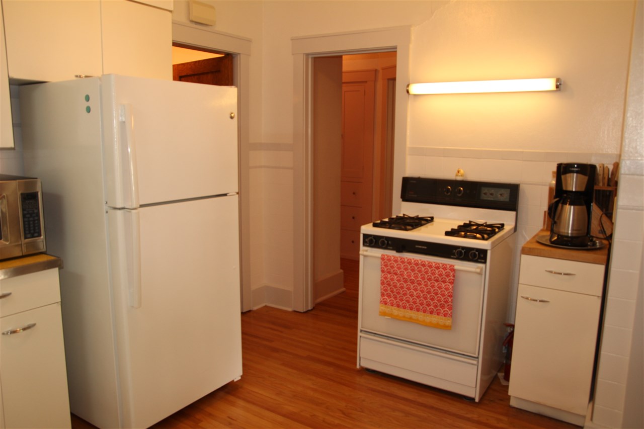 429 Dawson Avenue Rockford, IL 61107 - Photo 9 of 25 a white refrigerator freezer and a stove sitting inside of a kitchen