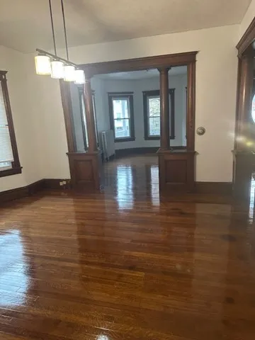a view of a living room with hardwood floor and a large window