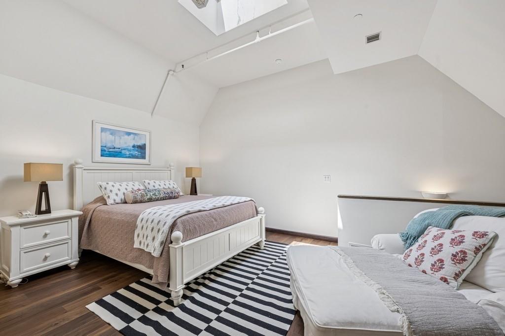 236 Edgemere Street, Unit 427 Montauk, NY 11954 - Photo 12 of 42 Bedroom with vaulted ceiling, dark wood-type flooring, and a skylight