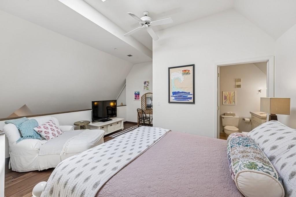 236 Edgemere Street, Unit 427 Montauk, NY 11954 - Photo 13 of 42 Bedroom featuring vaulted ceiling, wood finished floors, ceiling fan, and ensuite bathroom