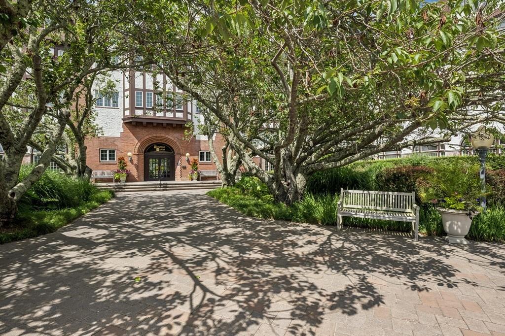236 Edgemere Street, Unit 427 Montauk, NY 11954 - Photo 2 of 42 View of front facade with french doors, brick siding, and driveway