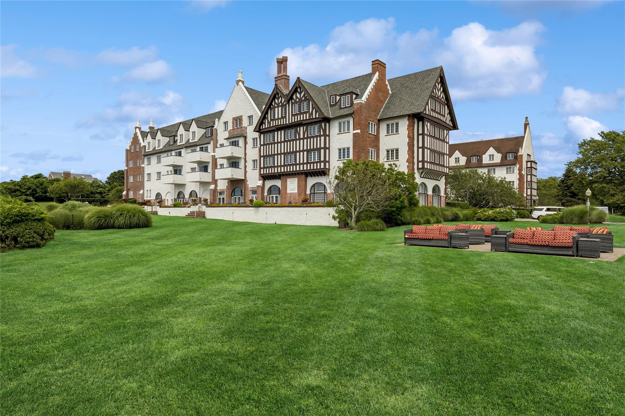 236 Edgemere Street, Unit 427 Montauk, NY 11954 - Photo 30 of 42 Back of property featuring a lawn and a chimney