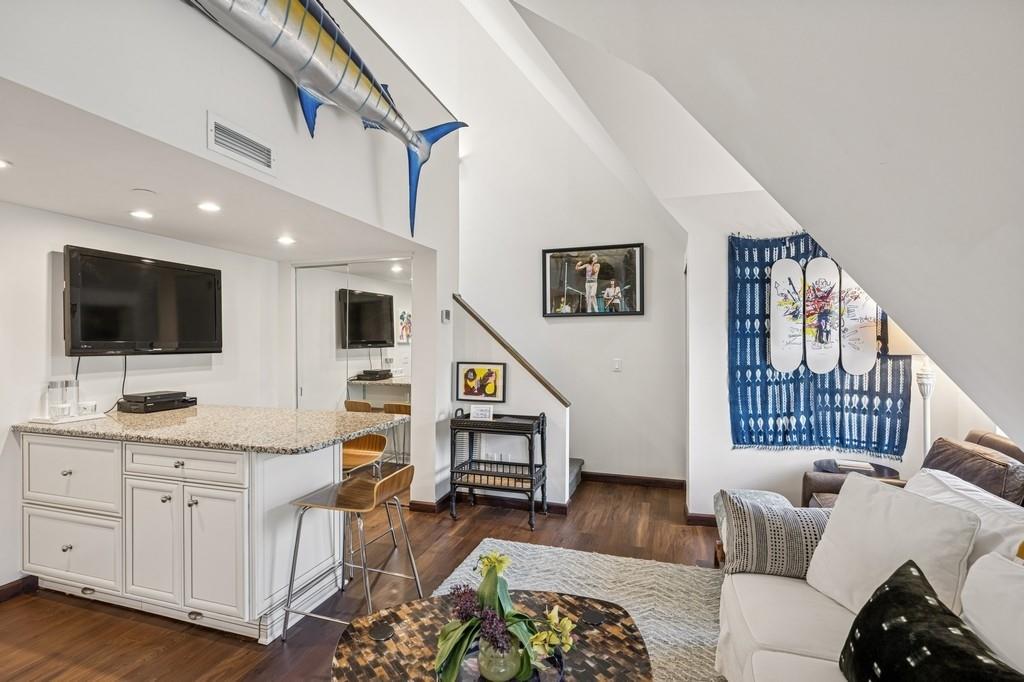 236 Edgemere Street, Unit 427 Montauk, NY 11954 - Photo 6 of 42 Living area featuring dark wood finished floors, stairway, recessed lighting, and high vaulted ceiling