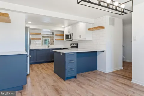 a kitchen with stainless steel appliances granite countertop a sink and cabinets