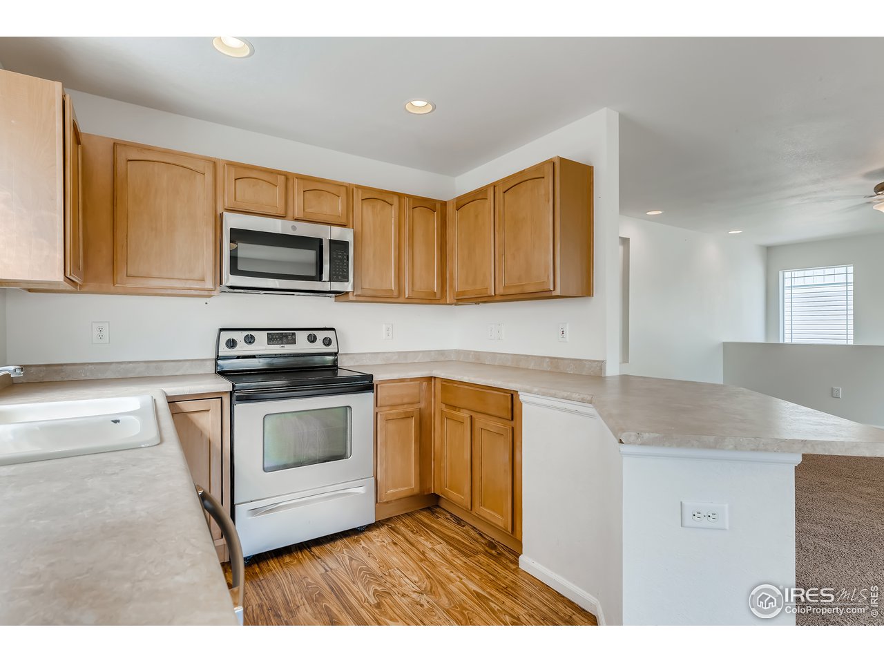 2175 Coach House Loop Castle Rock, CO 80109 - Photo 25 of 33 a kitchen with stainless steel appliances granite countertop a sink stove and microwave