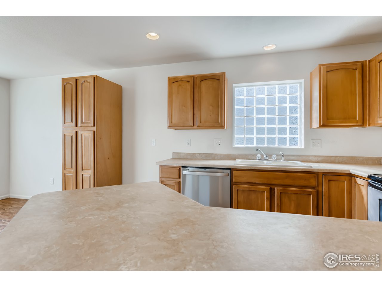 2175 Coach House Loop Castle Rock, CO 80109 - Photo 27 of 33 a kitchen with stainless steel appliances granite countertop a refrigerator a sink dishwasher a stove with wooden cabinets