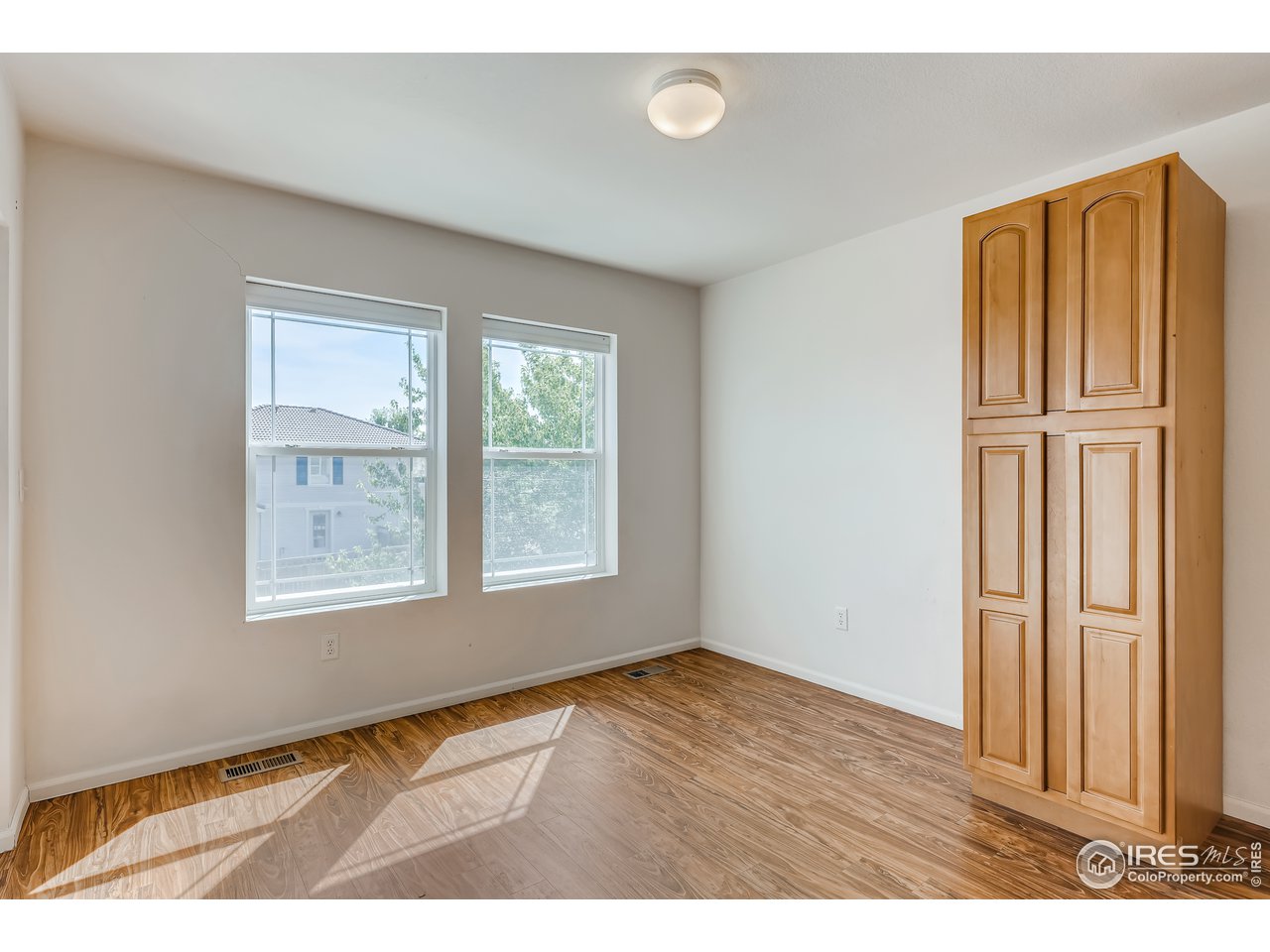 2175 Coach House Loop Castle Rock, CO 80109 - Photo 28 of 33 a view of an empty room with wooden floor and a window