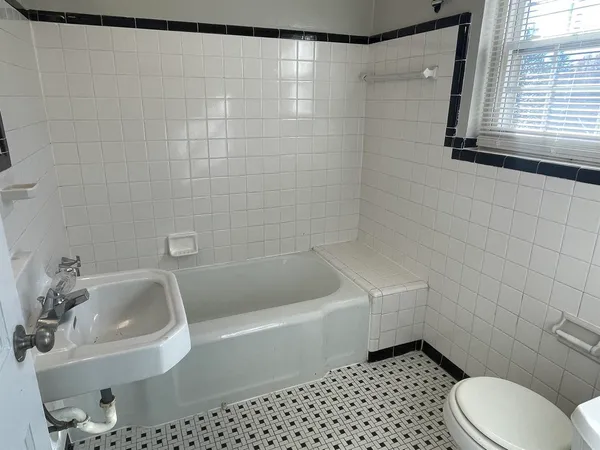 a bathroom with a sink a toilet and bathtub
