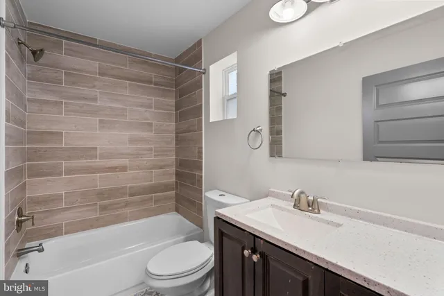 a bathroom with a sink toilet vanity and shower