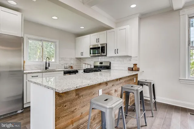 a kitchen with stainless steel appliances granite countertop a sink and cabinets