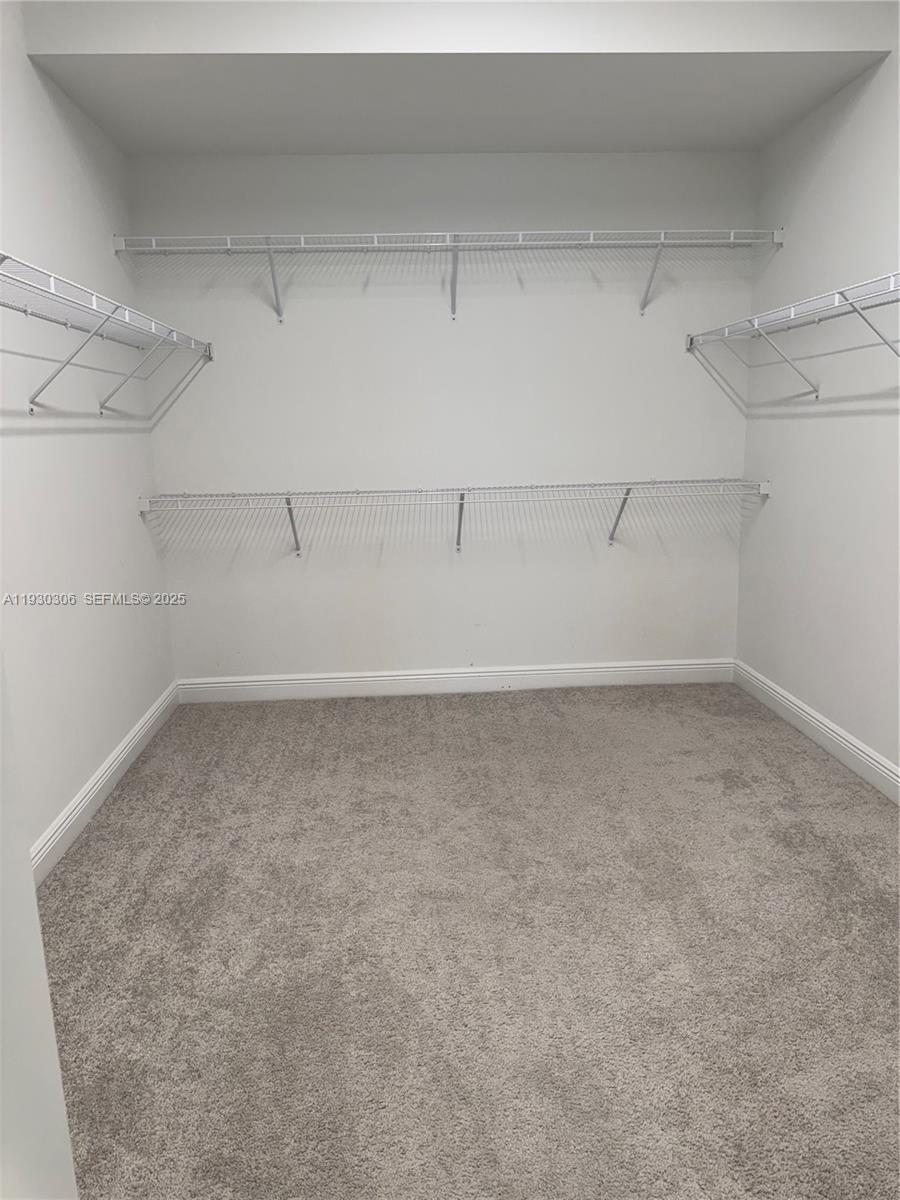 16456 Sea Turtle Place, Unit 16456 Westlake, FL 33470 - Photo 12 of 27 a view of a room with racks on the wall