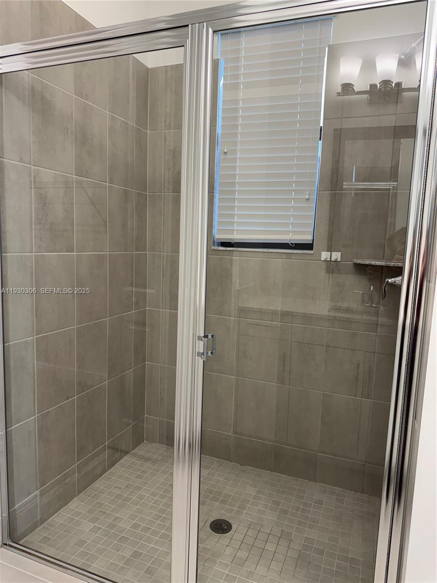 16456 Sea Turtle Place, Unit 16456 Westlake, FL 33470 - Photo 14 of 27 a bathroom with a shower