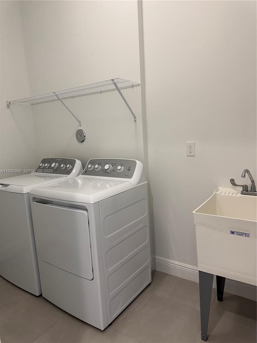 16456 Sea Turtle Place, Unit 16456 Westlake, FL 33470 - Photo 15 of 27 a utility room with dryer and washer